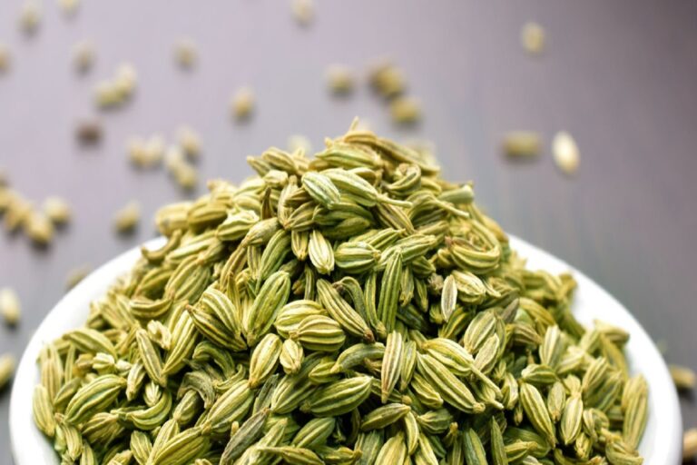 Fennel seeds in a bowl on a wooden table